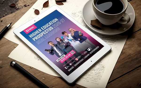 Image showing a tablet with the SERC Higher education prospectus on a wooden table, a coffee cup and pen and paper. 